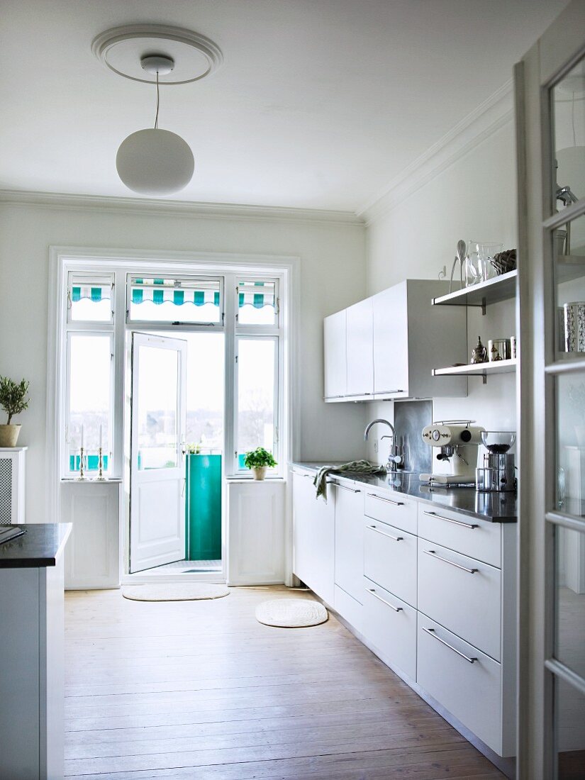 Functional kitchen with open balcony door