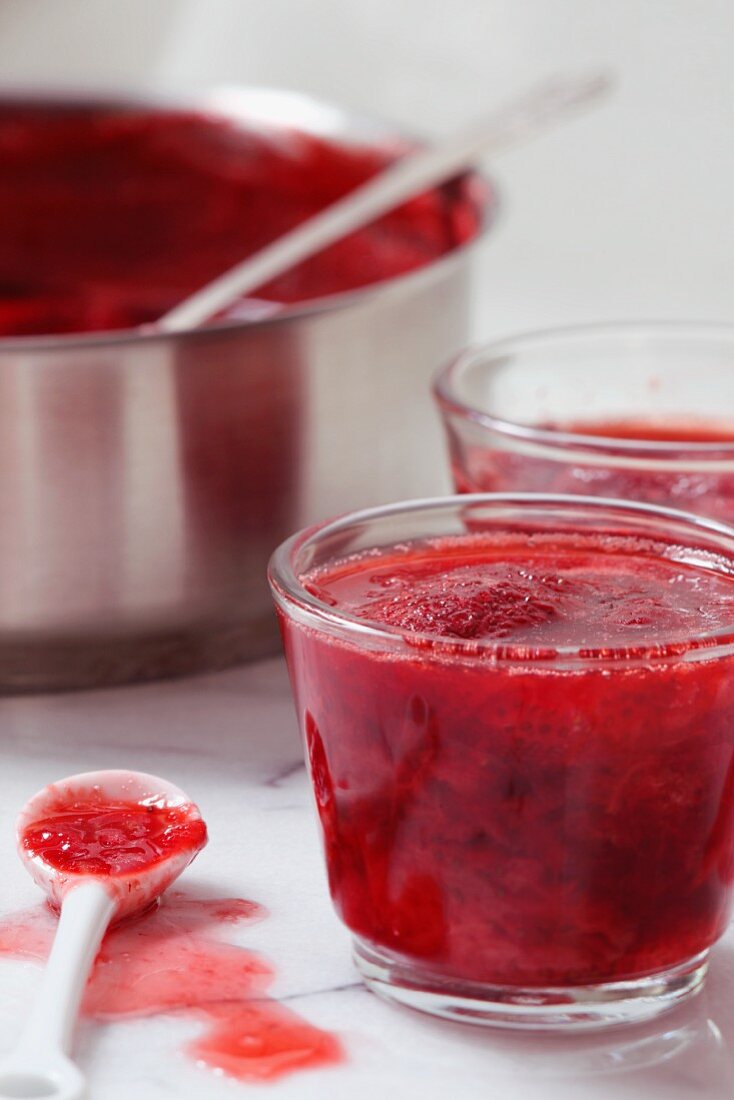 Homemade Strawberry Jam in Glass Cups; Strawberry Jam in a Pot