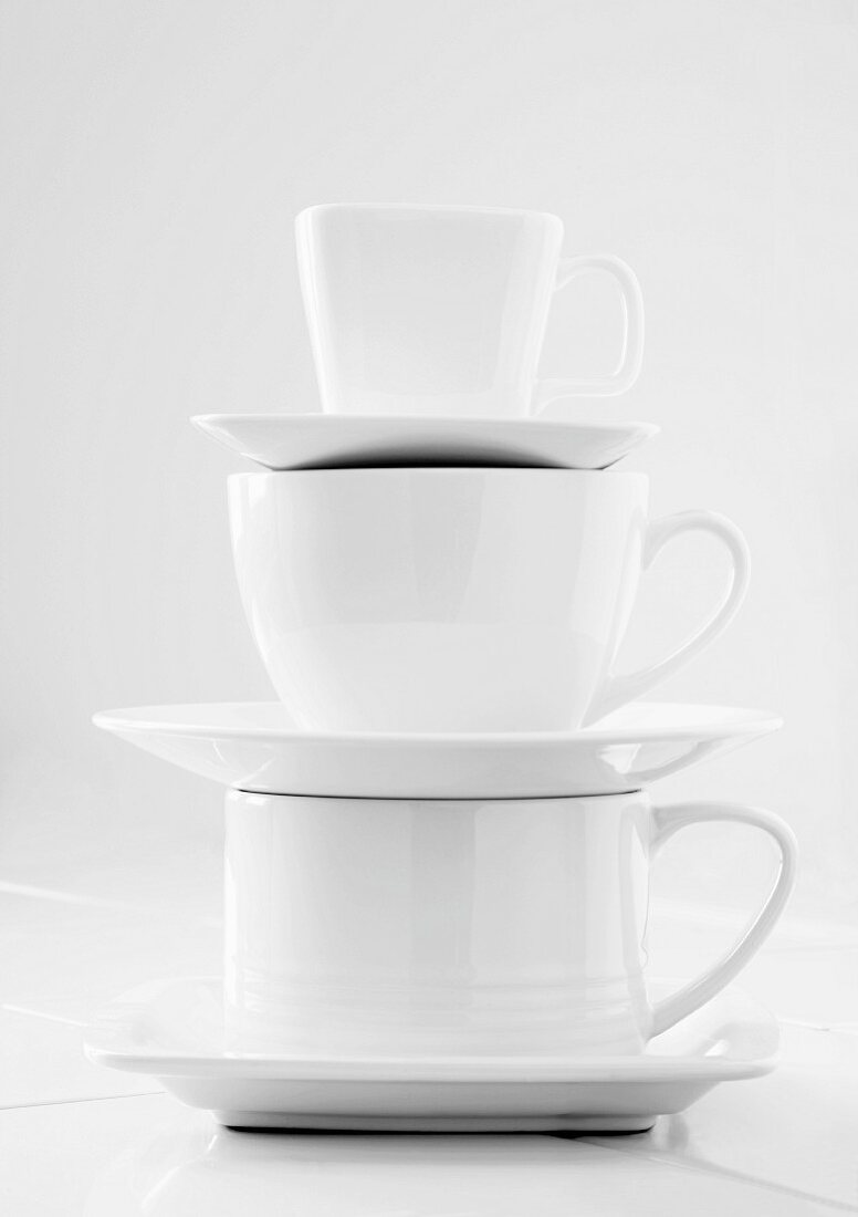 Stacked White Cups and Saucers; Large to Small