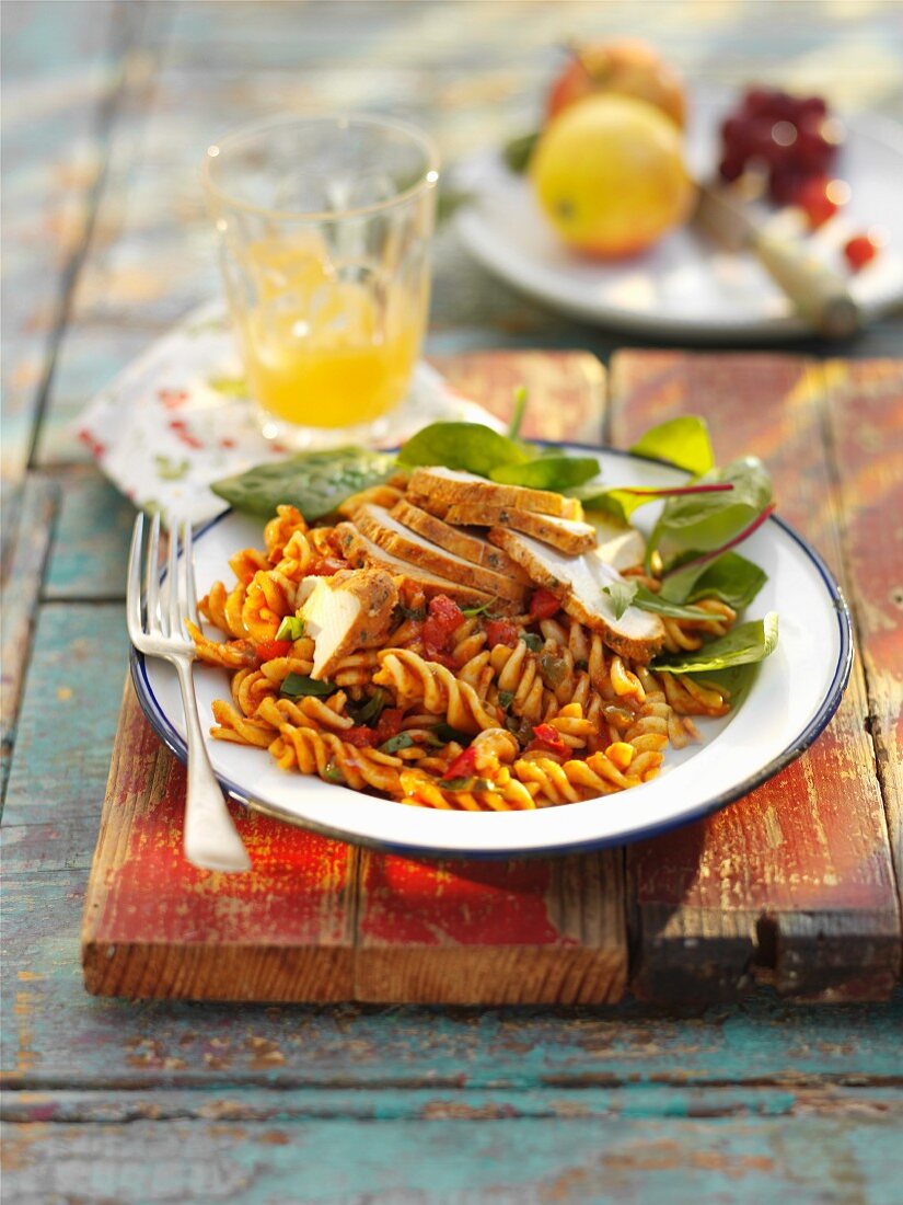 Pasta salad with chicken, tomatoes and basil