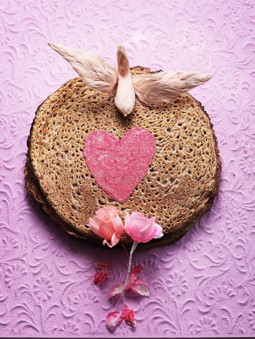 A pancake cake decorated with a heart