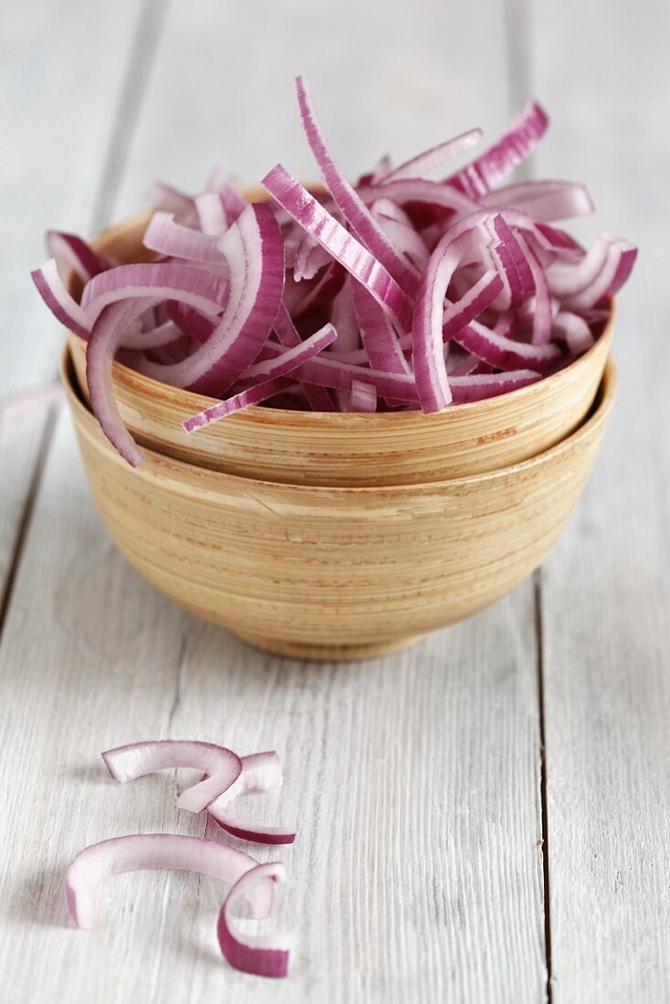 Sliced red onion in a wooden bowl