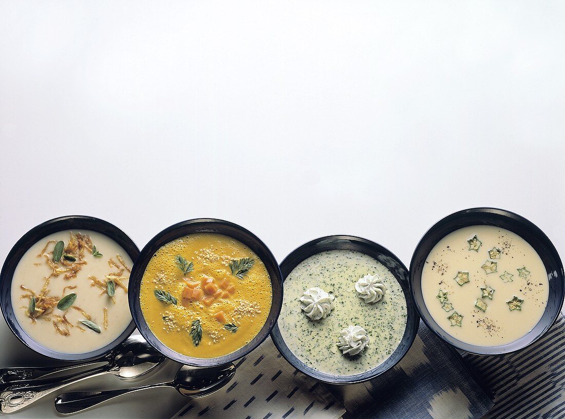 Assorted Cream Soups including Potato, Carrot with Sesame Seeds, Herb with Cream Garnish and Veal with Okra Pod Slices