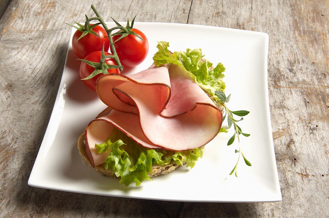 Open face sandwich with turkey ham and Lollo Bianco, thyme and cherry tomatoes