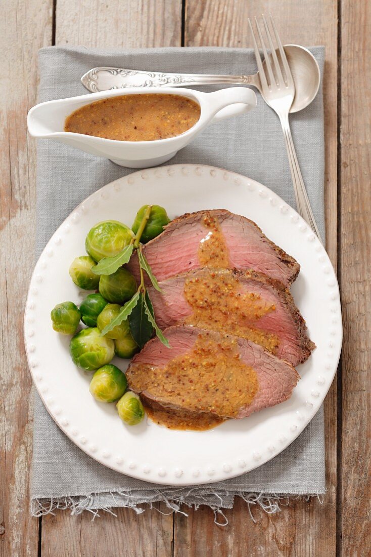 Roast beef with mustard sauce and Brussels sprouts