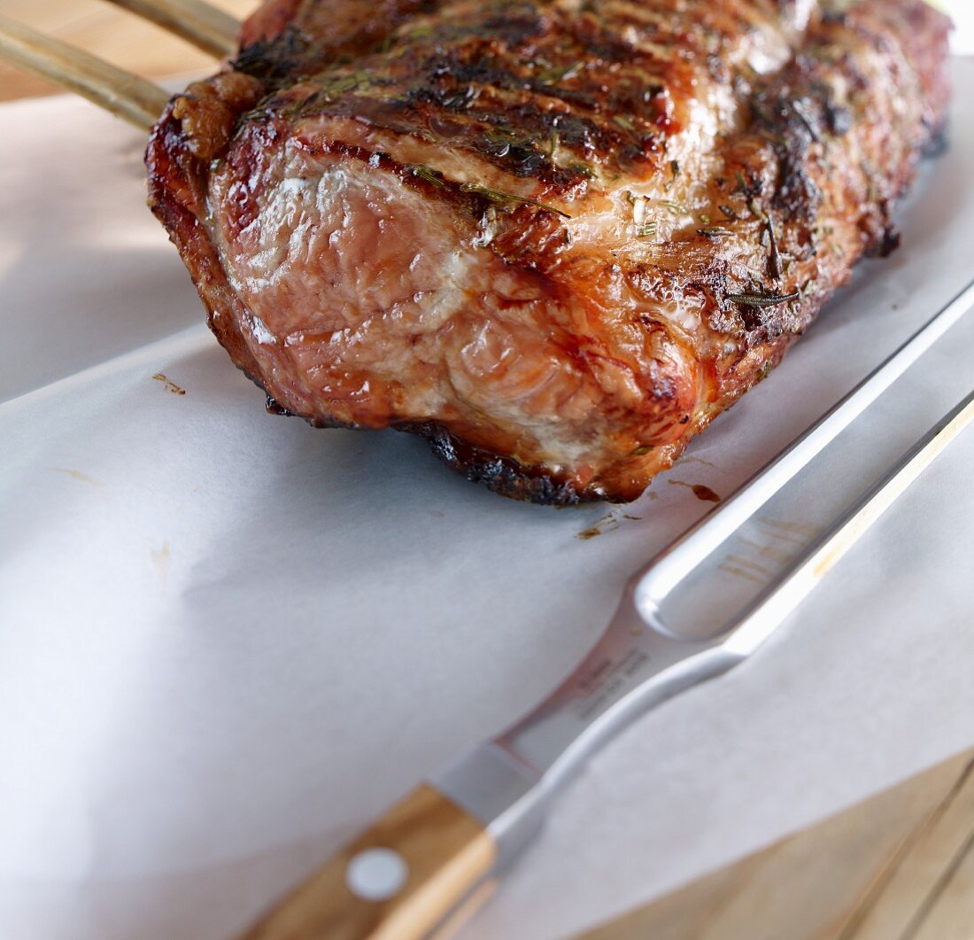 Veal loin with a meat fork on paper