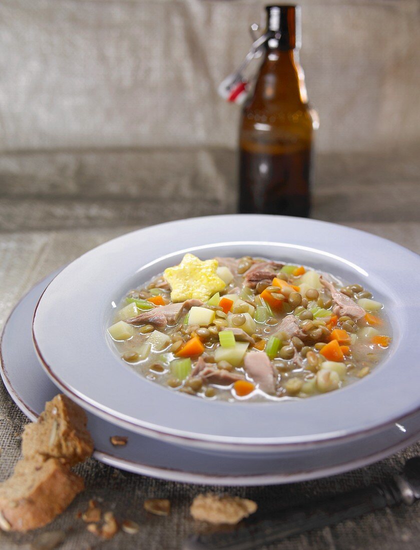 Pheasant soup with peas, carrots and potatoes