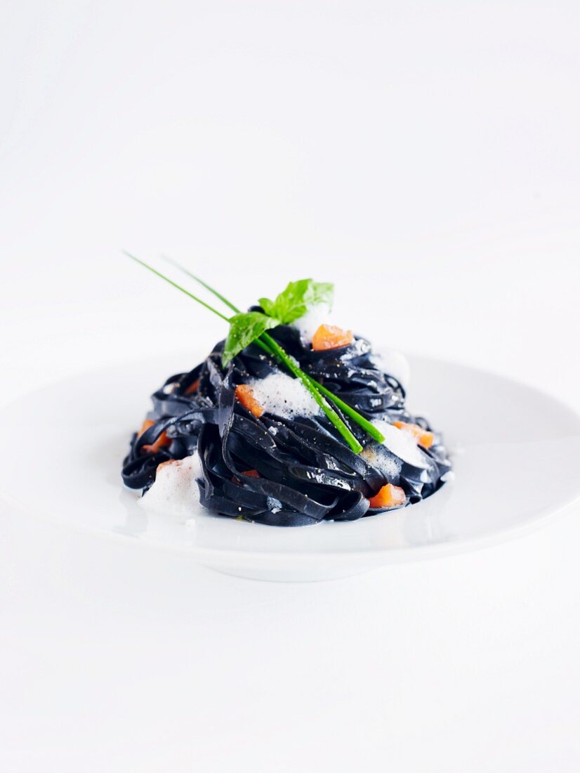 Black tagliatelle with a dollop of white foam