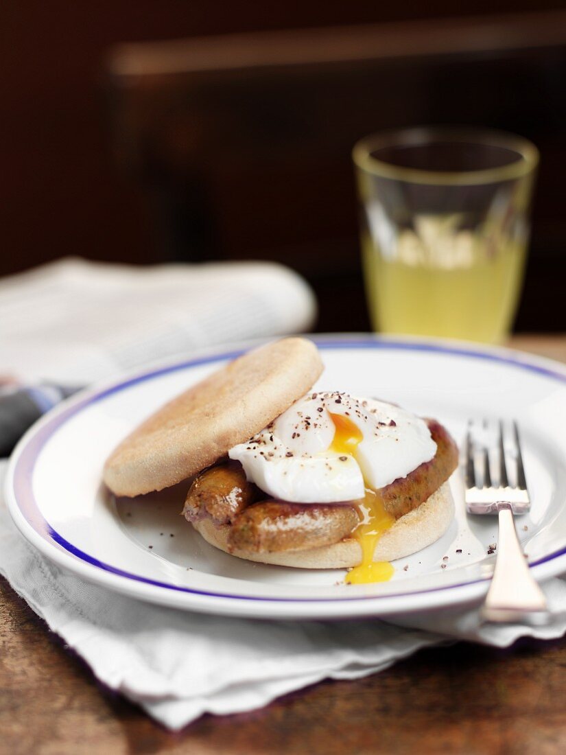 English muffin with sausage and poached egg