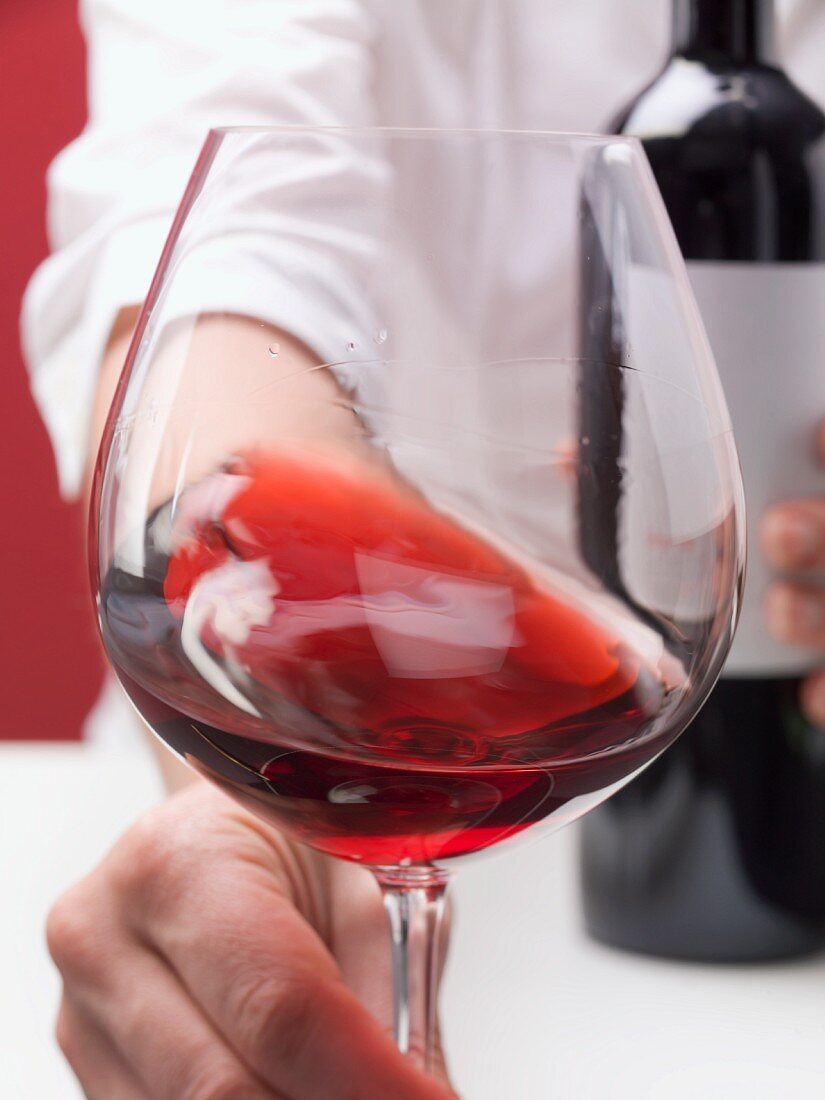 A glass of red wine with 'tears' (sign of of alcohol content)