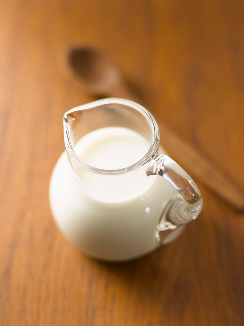 A jug of milk on a wooden table