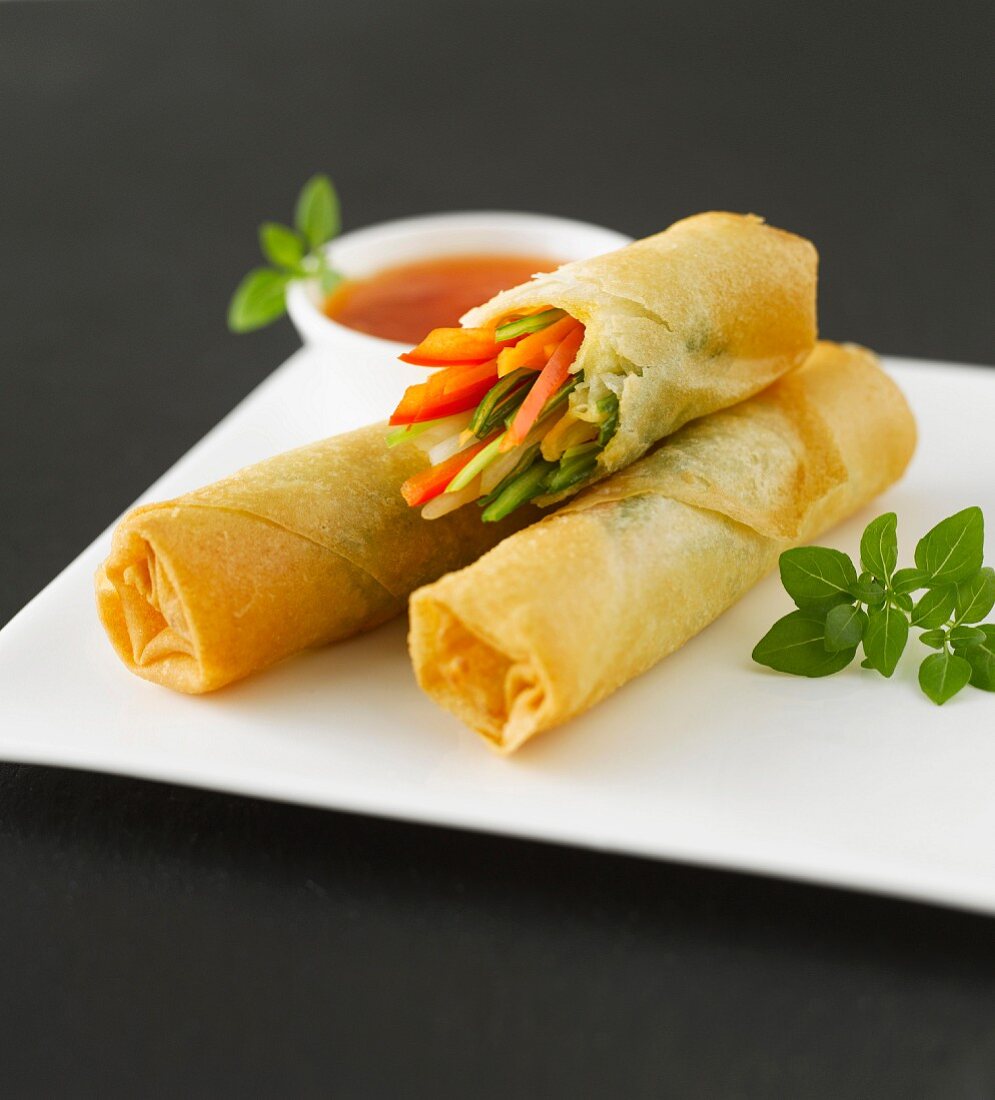 Spring rolls filled with vegetables, chilli sauce and oregano
