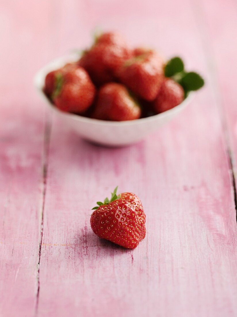 Strawberries on a pink wooden table