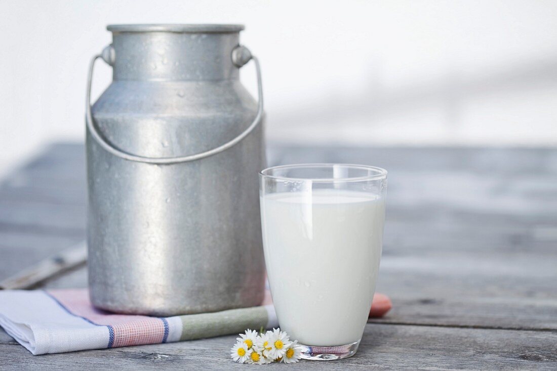A milk churn and a glass of milk
