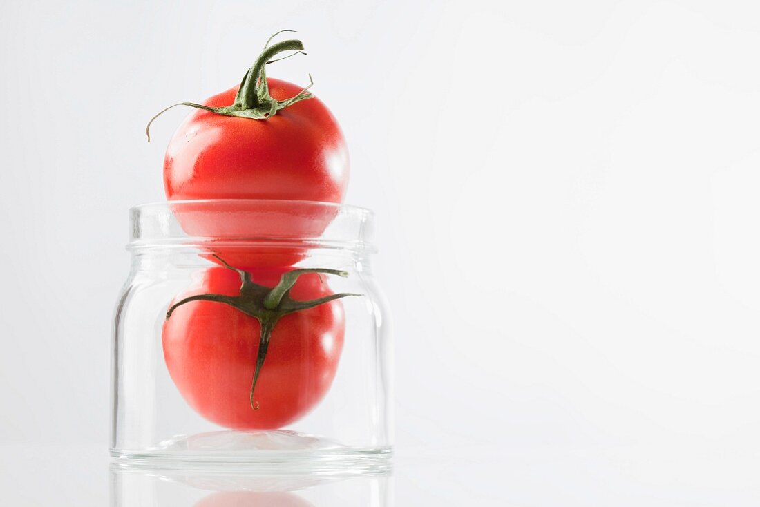 Two tomatoes in a jar