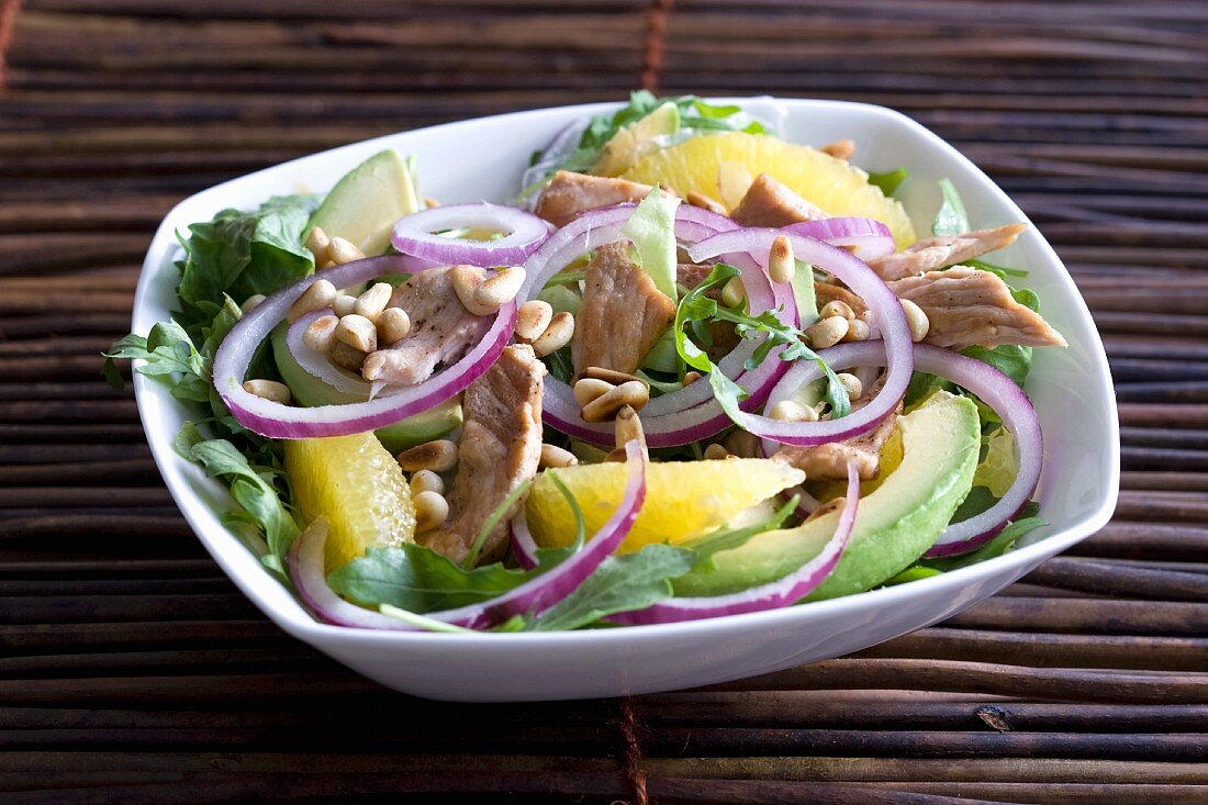 Vegetables salad with avocado, oranges and pork strips