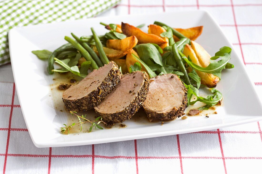 Oven-roasted pork fillet with a spice crust and vegetables