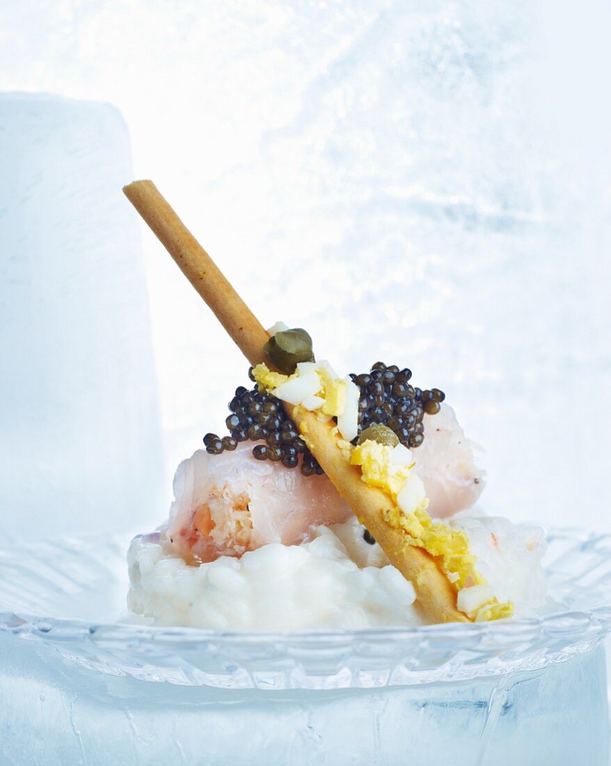 Risotto with caviar, raw fish, chopped egg and capers