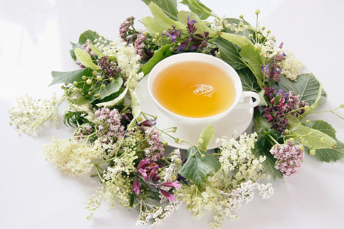 A wreath of flower and a cup of herbal tea