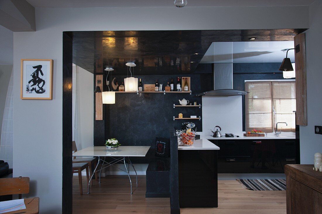 View of dining area and open-plan kitchen through wide doorway