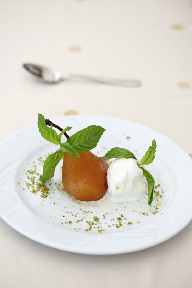 Poached pears with ice cream and mint