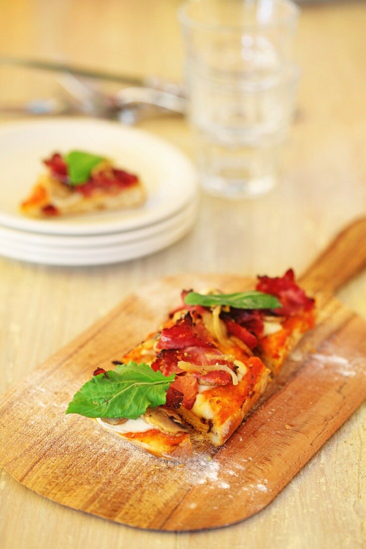 A slice of pizza on a wooden board