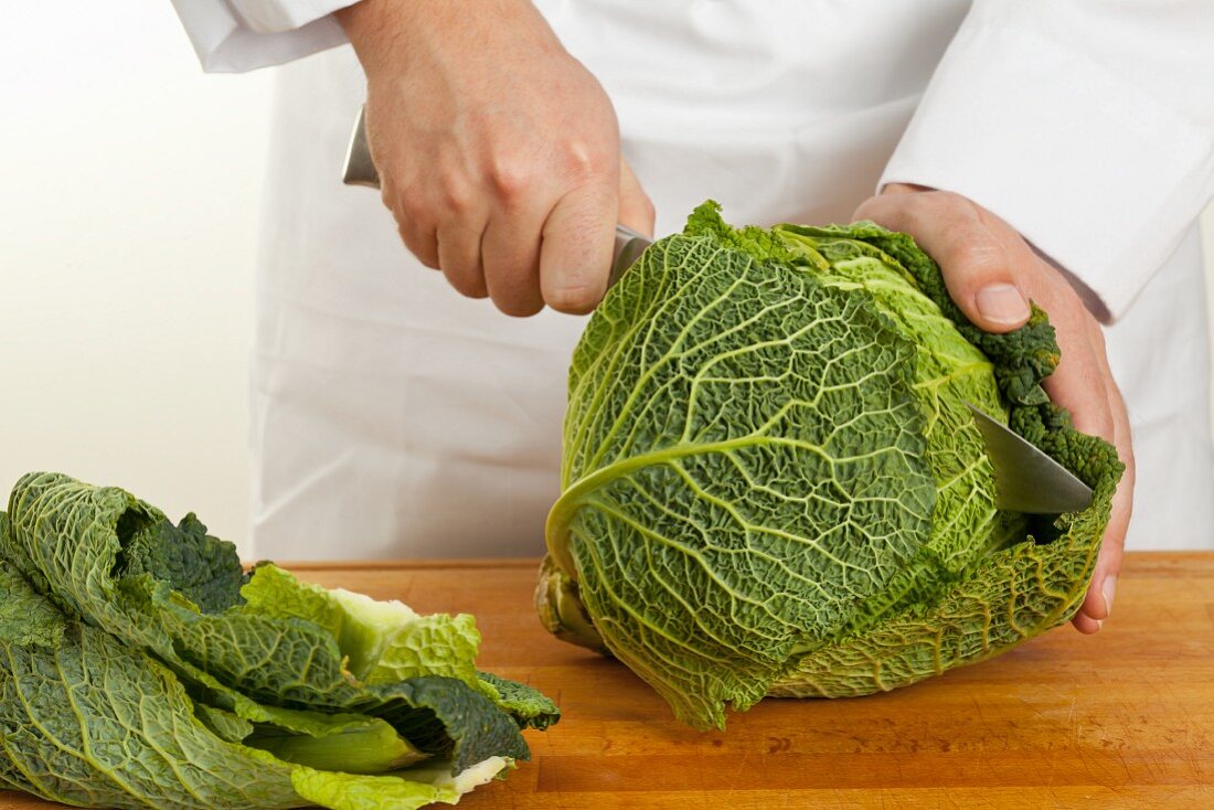 A savoy cabbage being cut in half