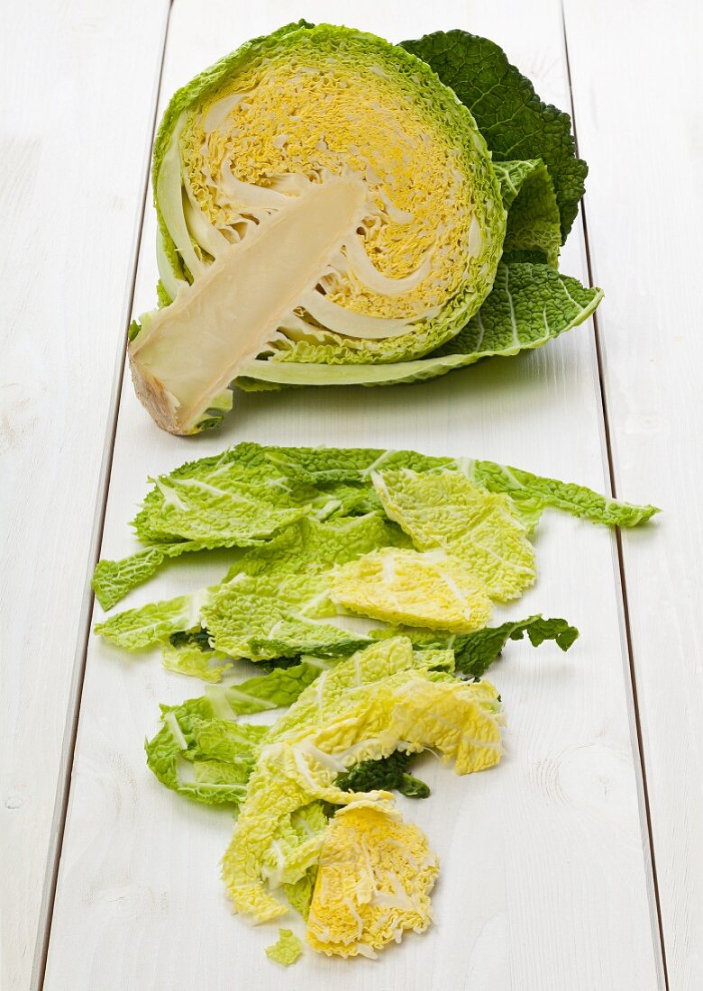 A savoy cabbage, whole and sliced