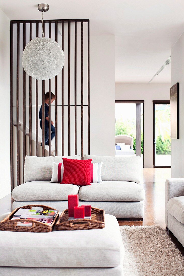 Child on staircase in living room with modern furnishings