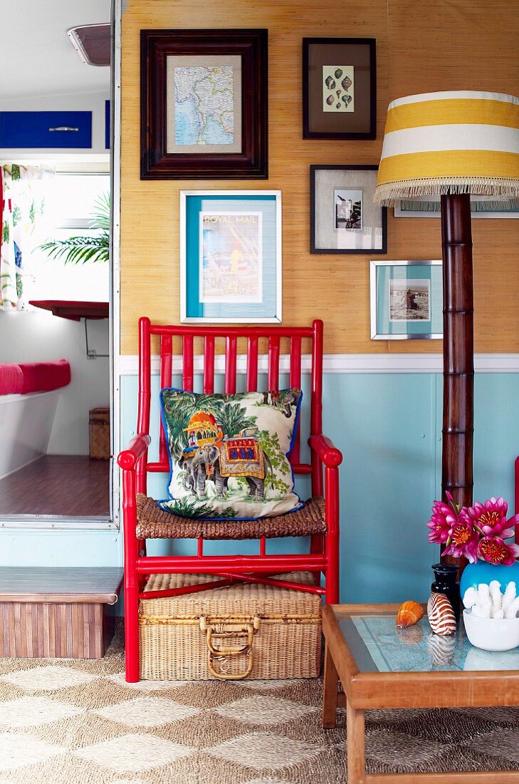 Sitting area with chair, floor lamp and coffee table in the living room of a holiday home