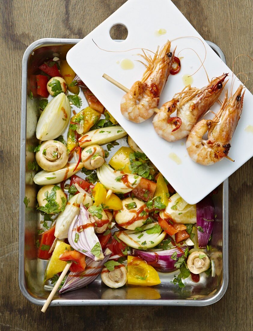 Oven-roasted vegetables with prawn kebabs