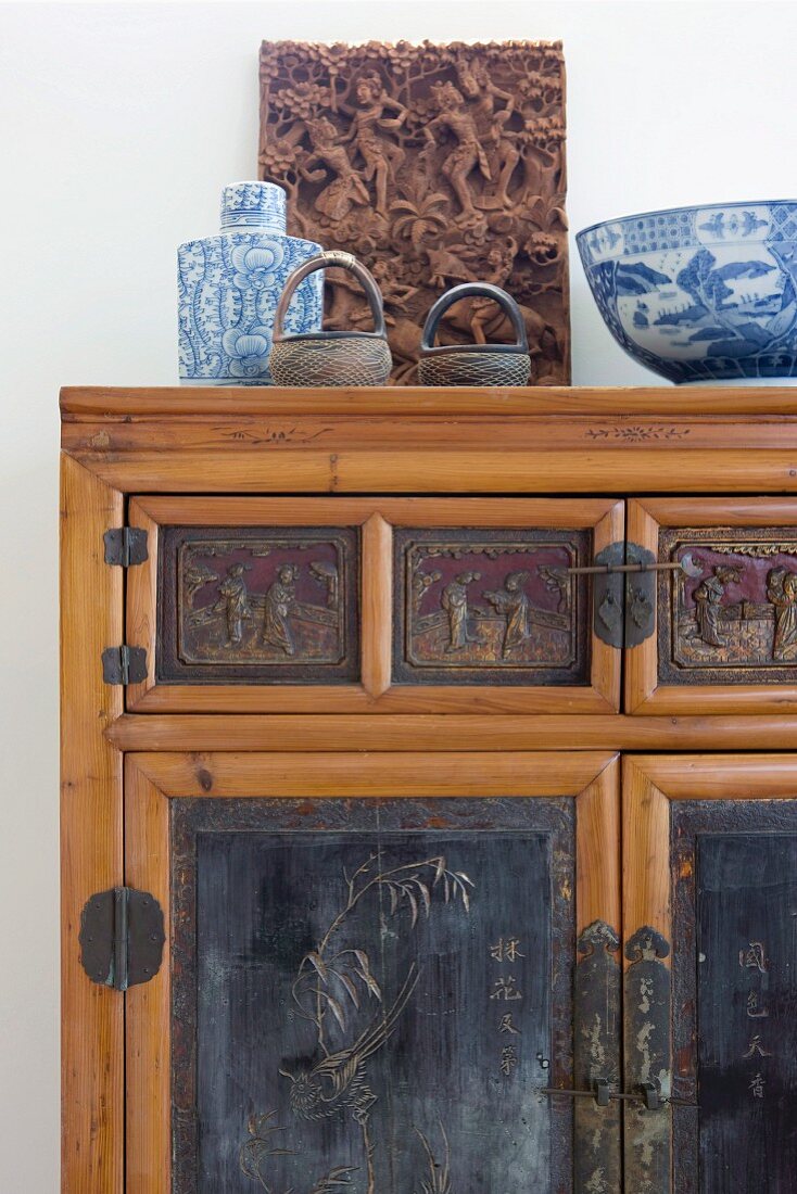 Oriental blue and white bowl on bamboo cabinet