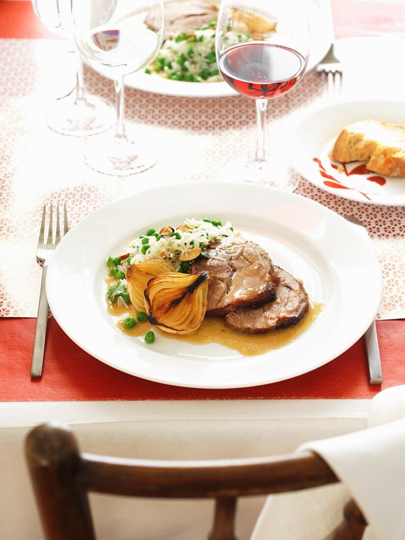 Roast pork with a ginger and honey glaze and pea rice