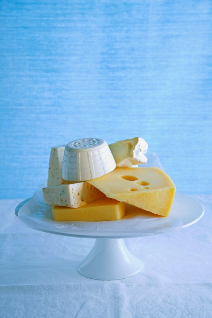 Various types of cheese on a cake stand