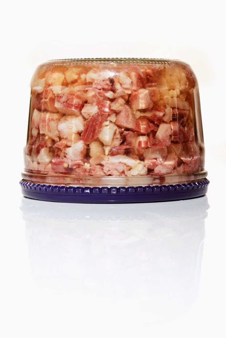 Pork head aspic in a screw top jar