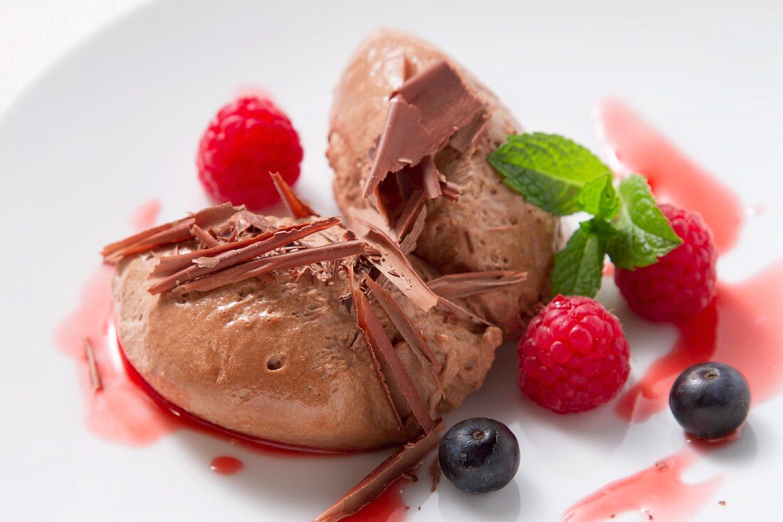 Mousse au chocolat garnished with fresh berries and mint