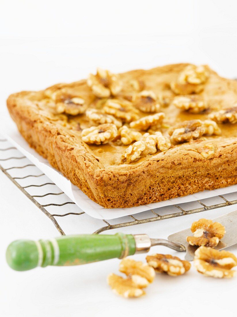 Blonde Brownies Topped with Walnuts on a Cooling Rack