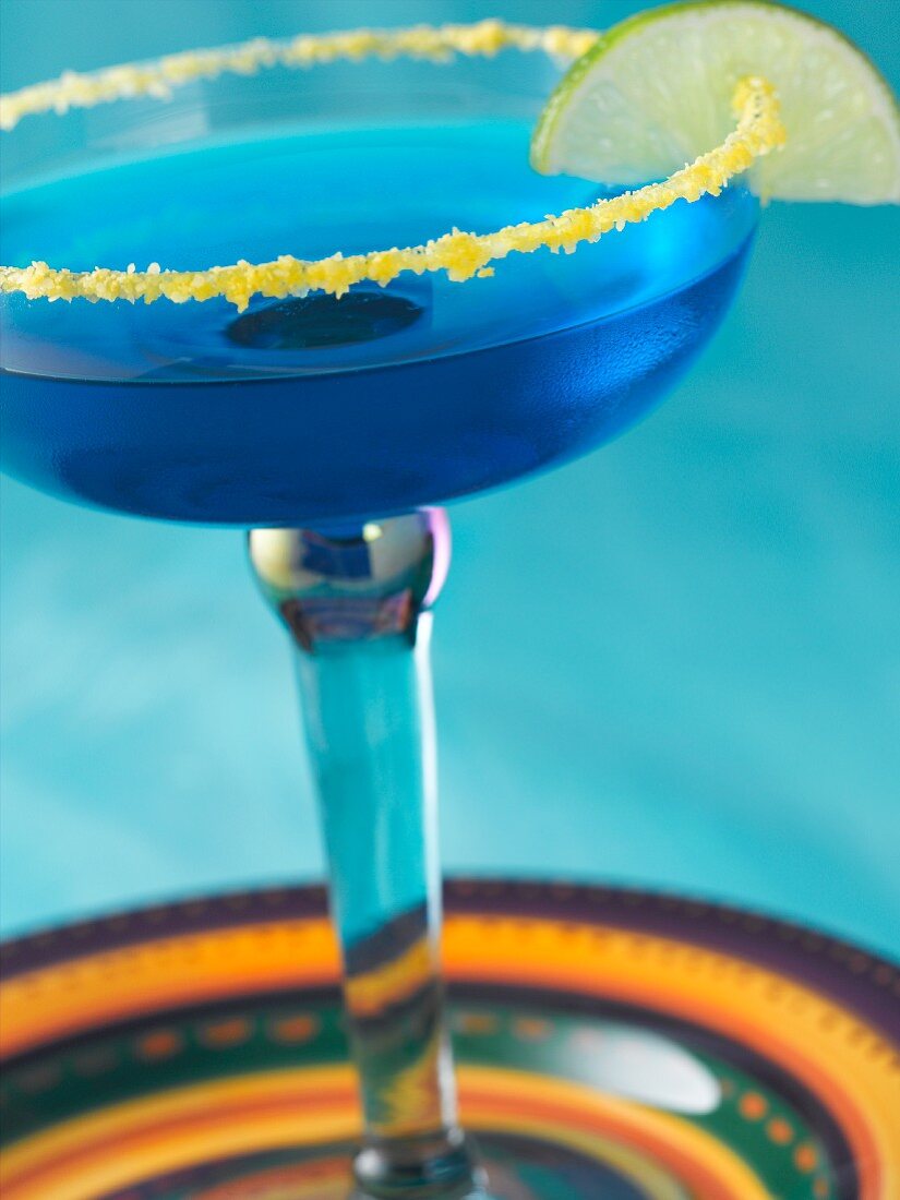 Blue Margarita in a Salted Rim Glass with a Lime Garnish