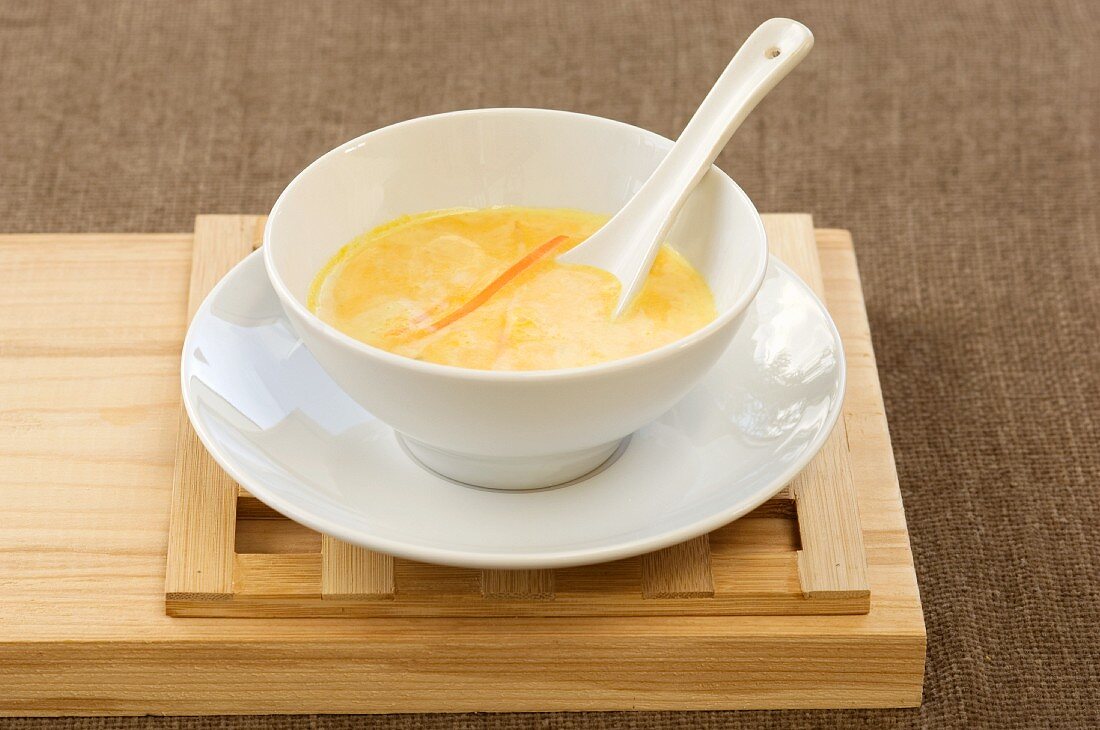 Carrot soup with carrot strips in an Oriental bowl