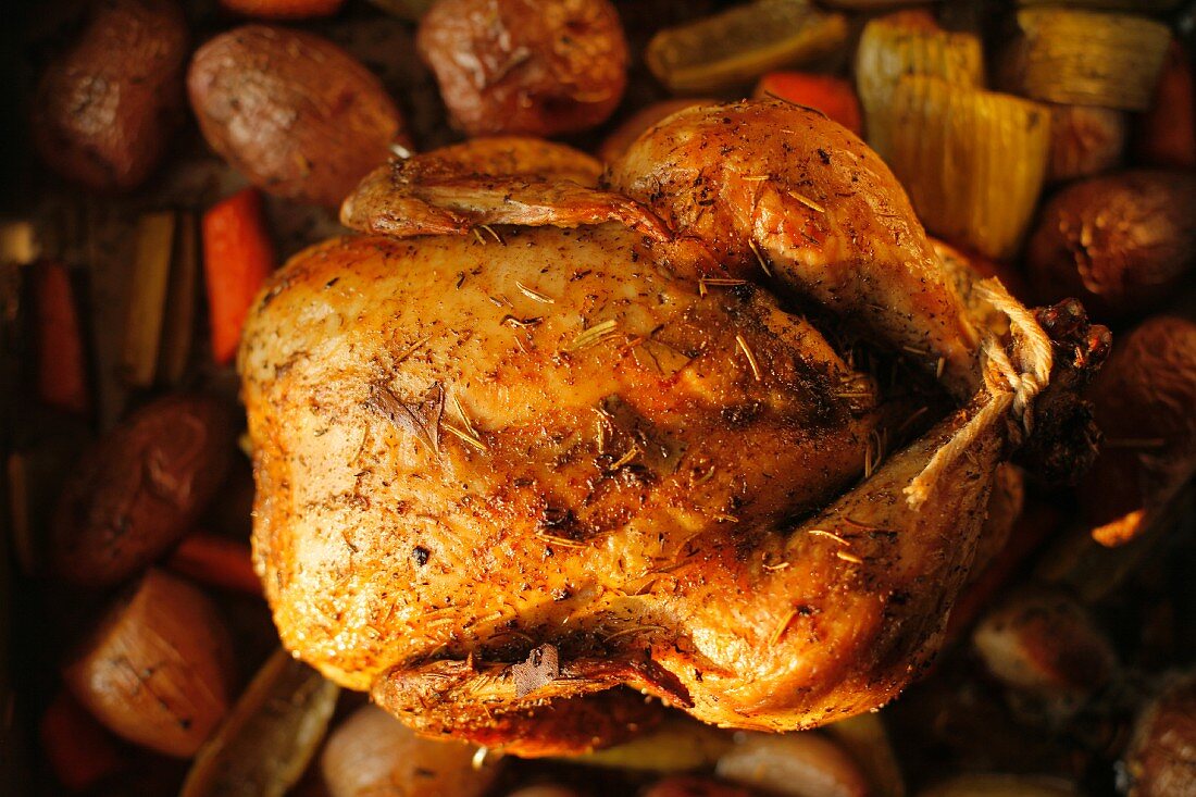 Whole Roasted Free Range Chicken with Herbs in a Pan with Organic Vegetables