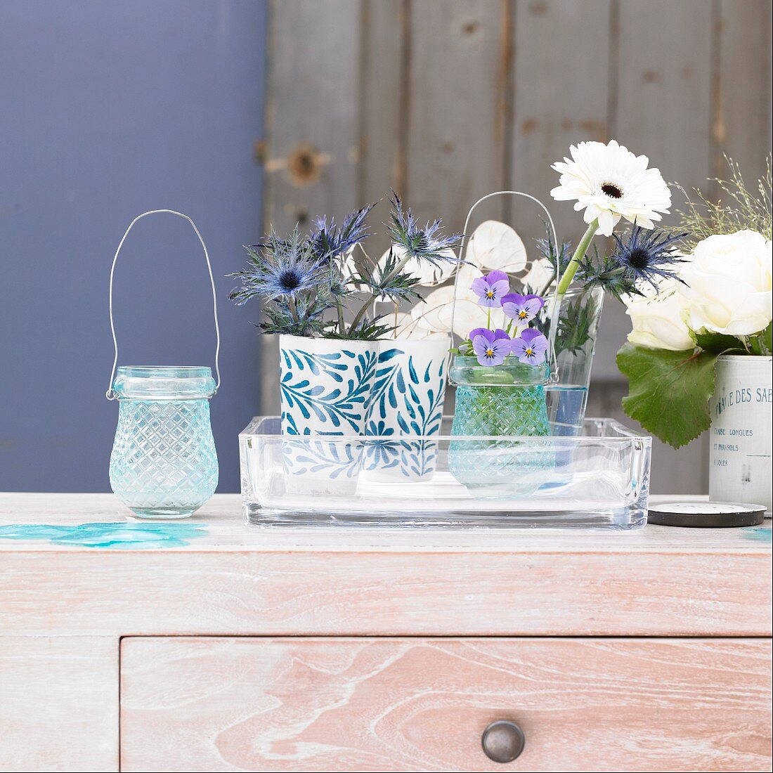 Blue and white flowers in vases on cabinet