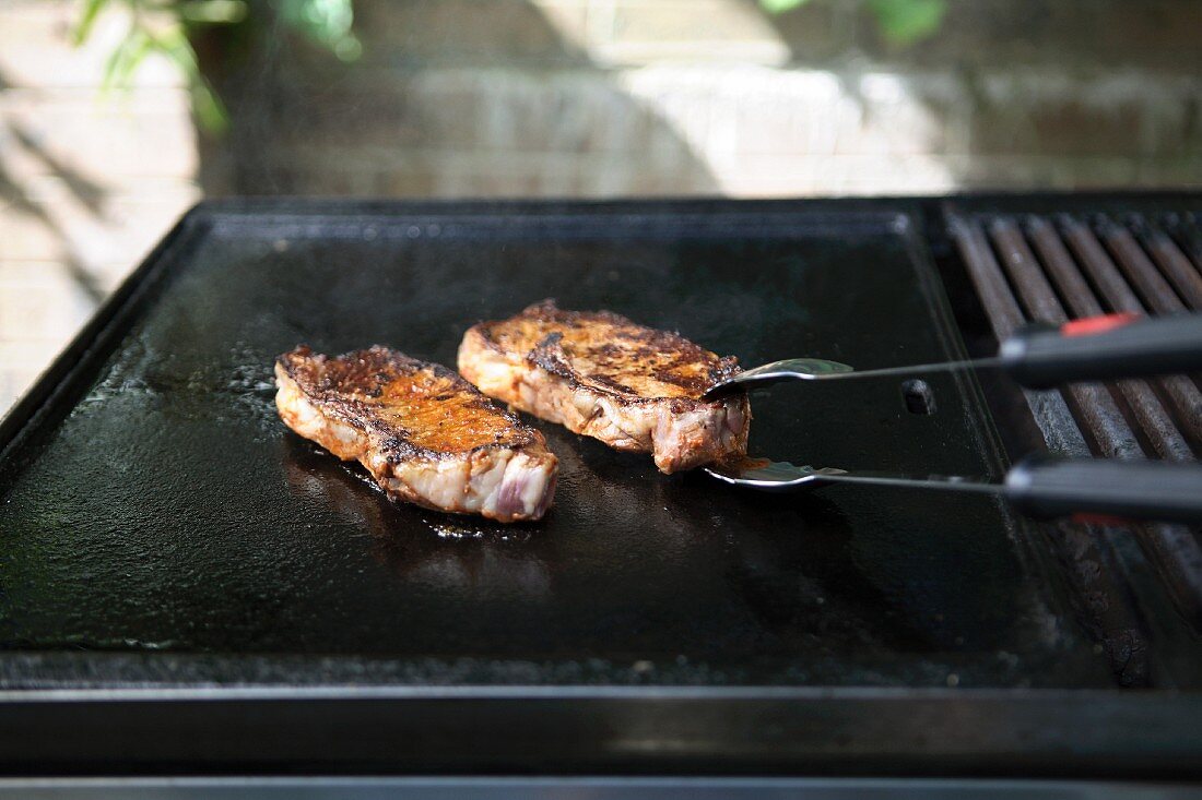 Slices of meat on a barbecue