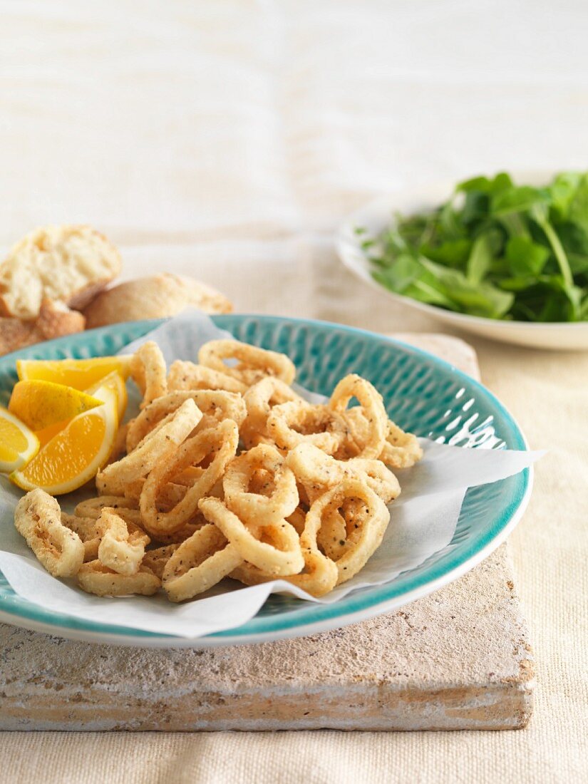 Squid rings with salt, pepper and lemon