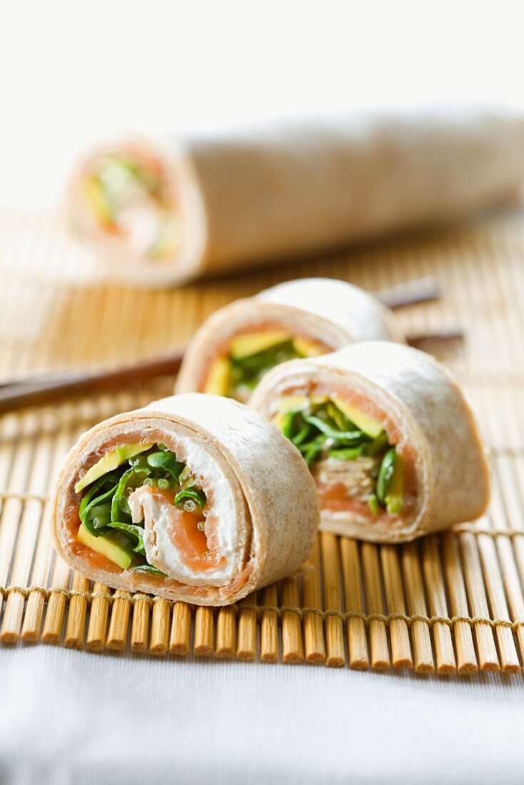 Tortilla rolls filled with avocado and salmon