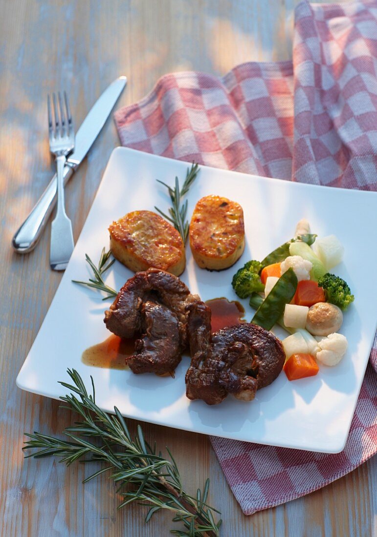 Veal breast with potato cakes and vegetables