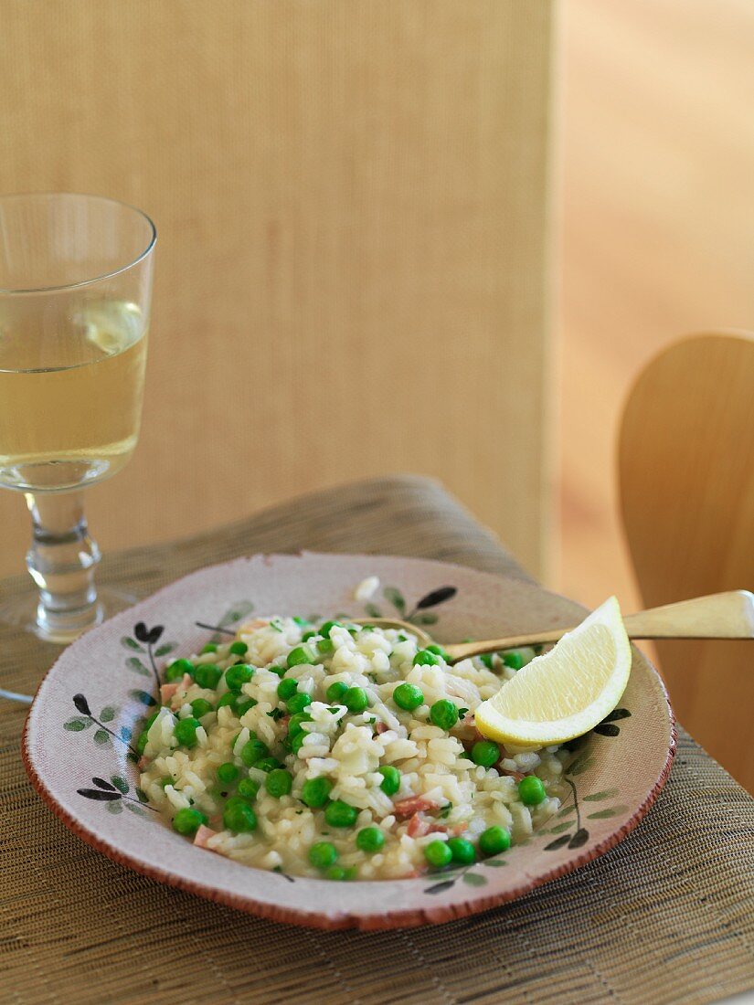 Risi bisi with a lemon wedge