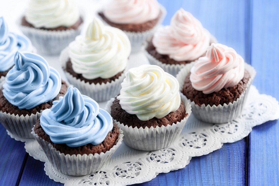 Chocolate cupcakes decorated with coloured cream