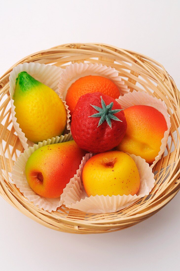 Various marzipan fruits in a basket