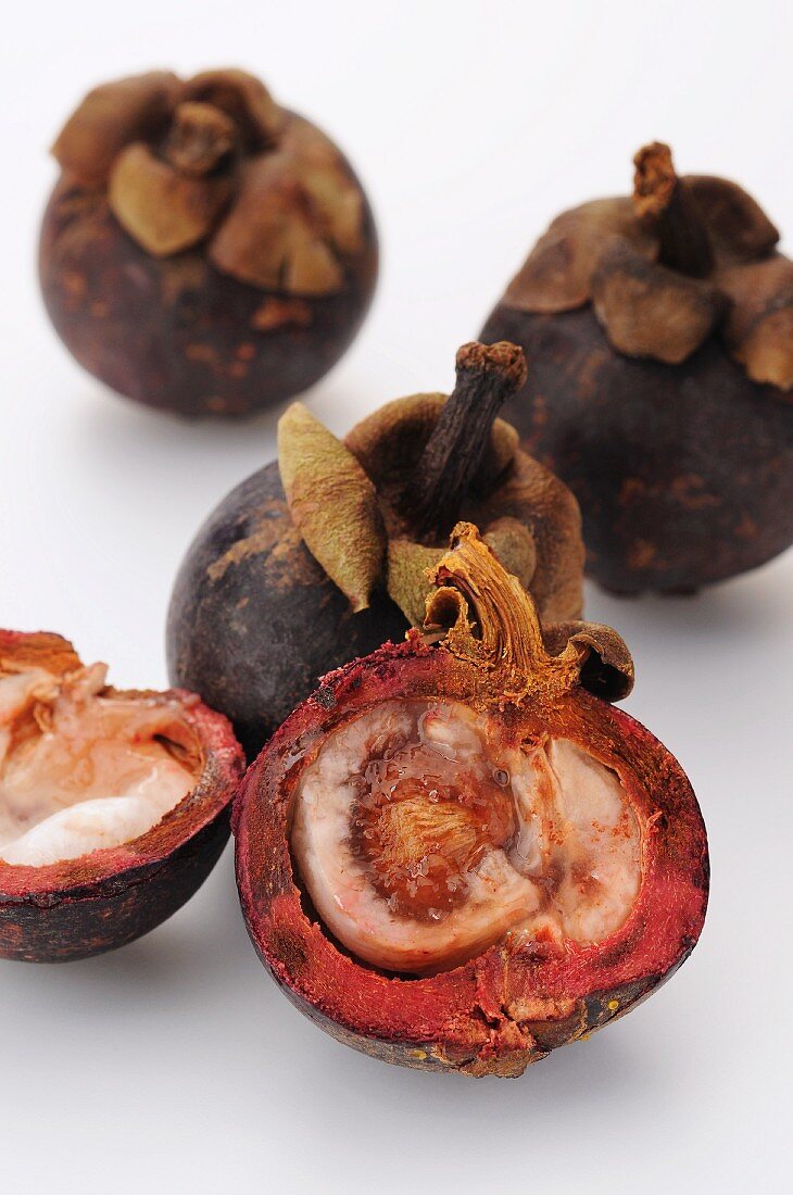 Mangosteens, whole and halved