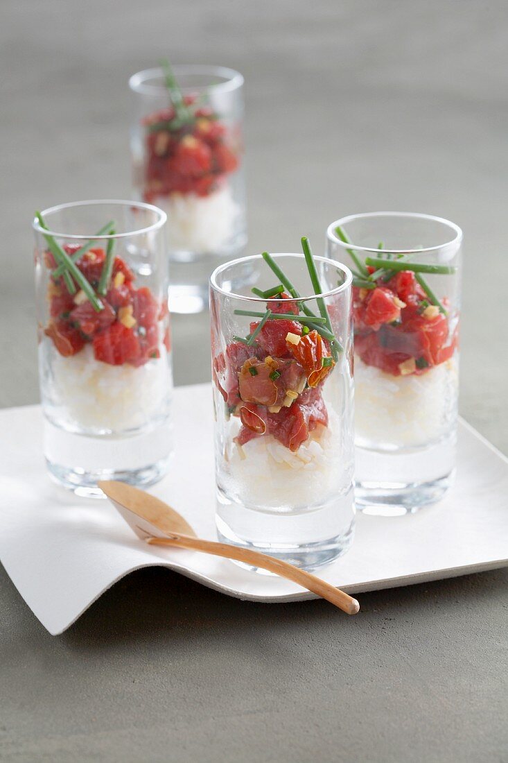 Rice with tomato confit served in glasses as an appetiser